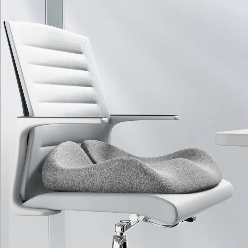 Gray office chair cushion on a white office chair with a light gray background